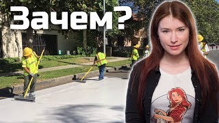 Люди красят асфальт в белый