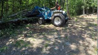 Cutting down trees with a tractor