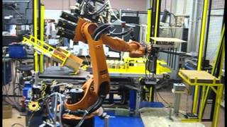 Kuka robot boxing jars and stacking boxes on pallets
