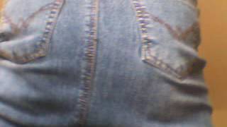 Muscle woman butt in a denim skirt