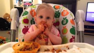 7 months old baby eating pasta with chicken. Baby lead weaning