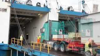 A woman driving the truck with oversize loads