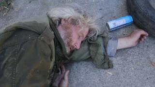 Guy pees on homeless dude.