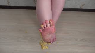 lady presses a banana with her feet ( Trampling, crush )