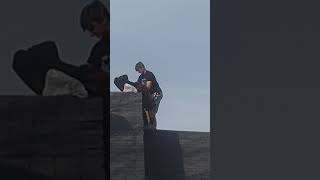 Kid throws poop off his house
