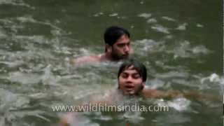 Young boys swimming in the step-well of Nizamuddin