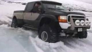Ford F350 monster truck towed by Suzuki Grand Vitara