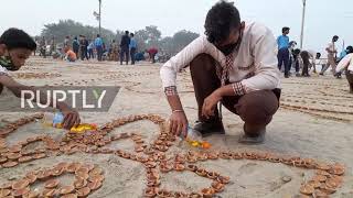Thousands of lamps and candles light up beach for Dev Deepawali festival