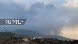 La Palma residents enjoy beach, put up Christmas lights with volcano smoke billowing in background