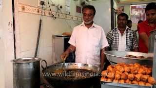 Cook stands behind his wok at local street-food kitchen
