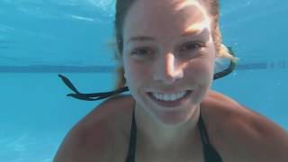 A delightful girl in a bikini swimming in the pool. Beautiful goddess takes herself on camera.