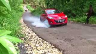 A woman driving on a steep uphill road