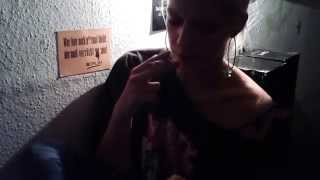 Girl dangling cigarette while texting