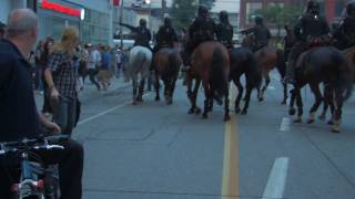 Toronto police march horses into people
