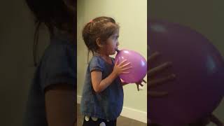 JAZZY BLOWING UP A BALLOON
