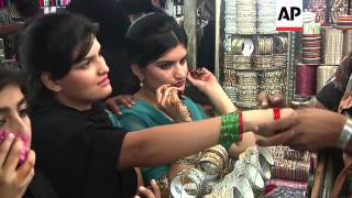 Shoppers throng markets in Karachi as people prepare for festival of Eid al-Fitr