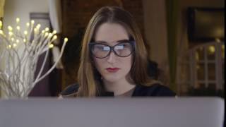 Girl in Glasses Working on Big Screen
