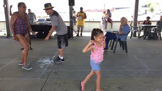 Little girl joins small group of dancers at Reggae on West Beach in New Bedford