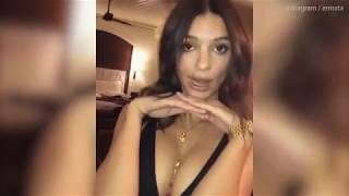Emily Ratajkowski shows off generous cleavage in dark dress