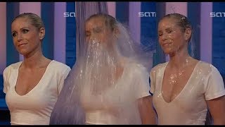 Good looking blonde woman soaked to the skin in nice white dress