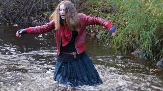 Girl dressed in kilt. Wet walk in hunters