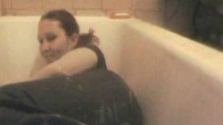 Girl wet jeans in bath