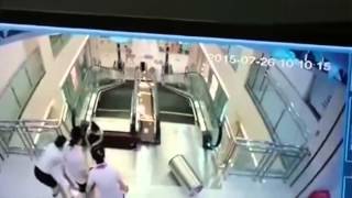 WARNING UNCENSORED China - Woman dies in escalator, saves son