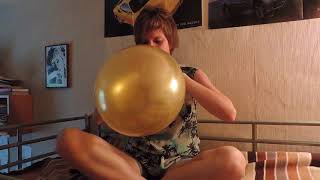 Girl blows up a pretty golden balloon until it pops || funny clip