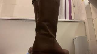 Brown Riding Boots Camouflage Trousers Trampling a Bottle of Water