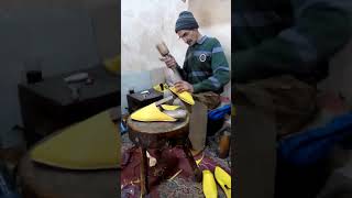 Craftsman making a babouche in Fes, Morocco