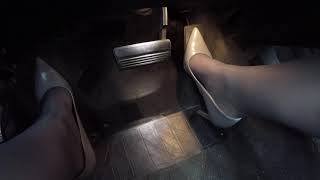 driving in grey heels and off black hose from the left side
