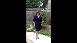 Redheaded crossdresser in purple on pool deck