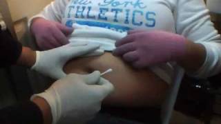 my cousin getting her belly button pierced