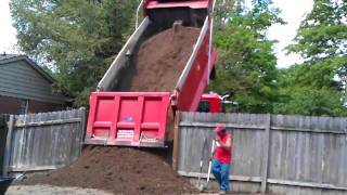 Tri axle of dirt getting dumped