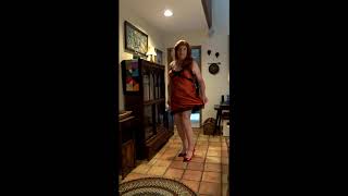 Crossdresser wearing an orange silk slip with black lace