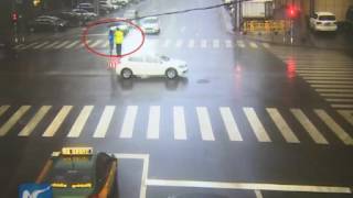 Woman raises umbrella for traffic police in rain