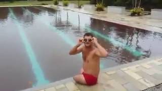 An Amputee Man Is Enjoying Swimming In The Pool.