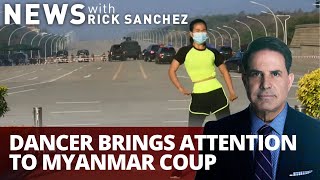Watch her dance while tanks roll as coup happens behind her