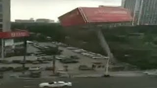 Billboard falls in parking lot, damaging cars