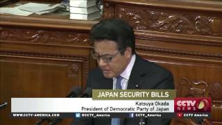 Japan's lower house approves controversial bills amid protests