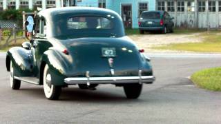 Classic cars pulling out of 50's diner
