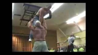 Strongman wrestler lifts with one hand