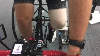 Amputee riding a trike on rollers