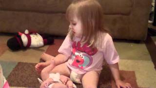 Toddler finds surprise in doll's diaper!