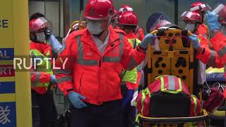 Hong Kong: Fire that trapped dozens on trade centre roof brought under control