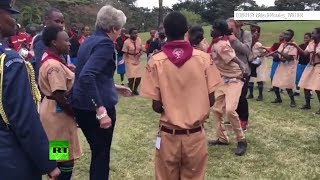 Theresa May boogies with scouts in Kenya