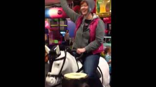 Woman riding pony at Chuck E Cheese