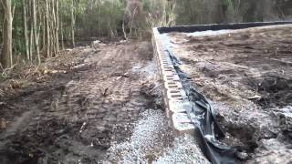 Commercial Retaining wall install in a swamp constructed by Always Blooming Landscape of N.W.FL