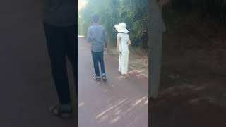 Chinese LHD amputee one leg lady strolling in the park on one crutch gracefully with her boyfriend