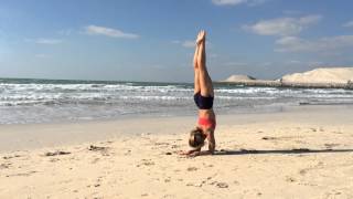 Yoga Dubai Pinchamayurasana on the Beach with Kino